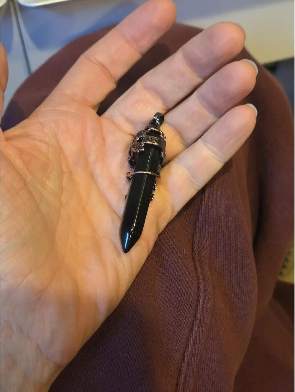 Black Point Pendant with Ornate Silver-Tone Floral Detail